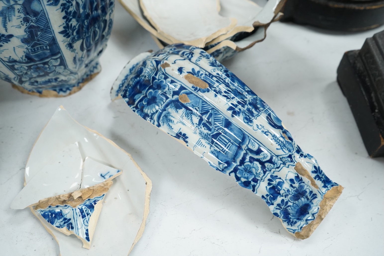 A late 17th century Delft faceted blue and white vase, by Lambartus van Eenhorn, and another broken similar, 29cm high (a.f.)